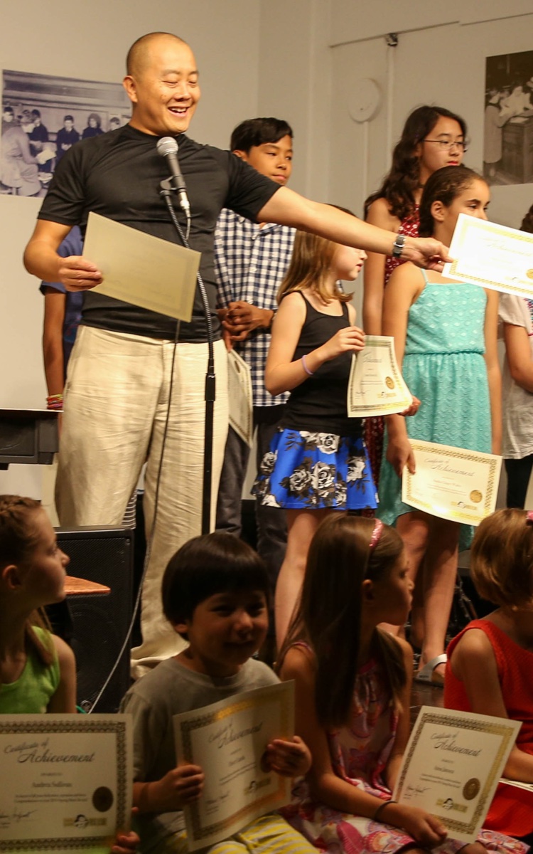 Andrew Ingkavet presenting at a music recital